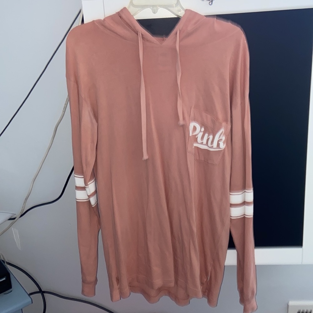 NWOT.. PINK long sleeve hooded tee .New condition. Size Small.Fits Like A Medium